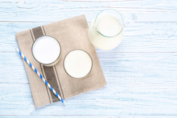 Fototapeta na wymiar Glassware with milk on wooden table. Fresh dairy product