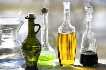 Glass bottles and vase on the window background