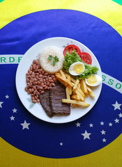Typical Brazilian food dish - Brazilian flag in the background