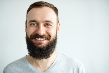 Portrait of a beautiful real hipster man teeth smile with a full face of a beard and mustache on a...