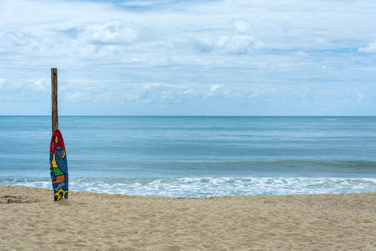 Colorful surf board on the sand at the Armacao Beach