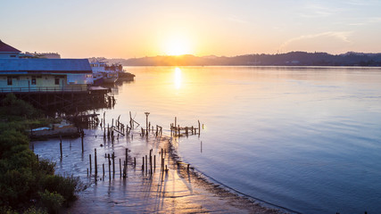 wooden houses over Mahakam riverbank, Borneo, Indonesia when sunrise