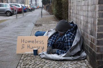 Male Beggar Lying On Street