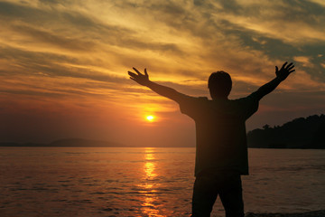 Fototapeta premium Silhouette business people victory raising hands with sunset sky. Motivation and success concept.