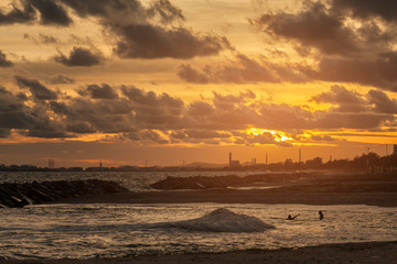 Fototapeta na wymiar Sunset on a beach splashing waves sand rocks in twillight.selective focus.