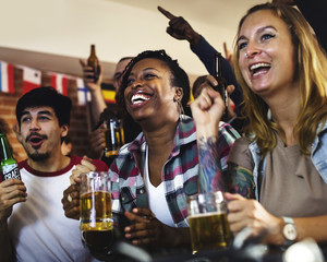 Friends cheering sport at bar together