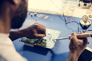 Closeup of tin soldering with electronics circuit board
