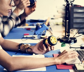 Side view of man working on robot