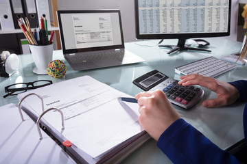 Businessperson Calculating Invoice - obrazy, fototapety, plakaty