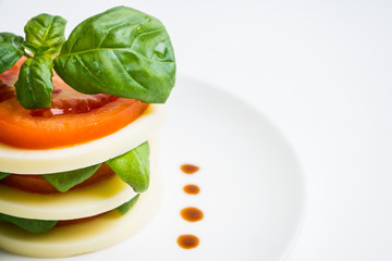 Salad Caprese with mozzarella and tomato. Layers served. Selective focus.