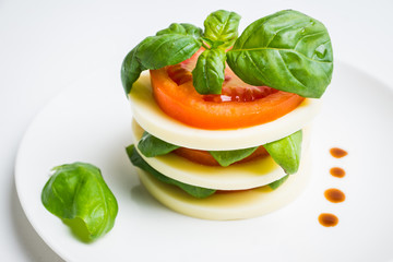 Salad Caprese with mozzarella and tomato. Layers served. Selective focus.