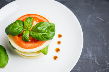 Salad Caprese with mozzarella and tomato. Layers served. Selective focus.