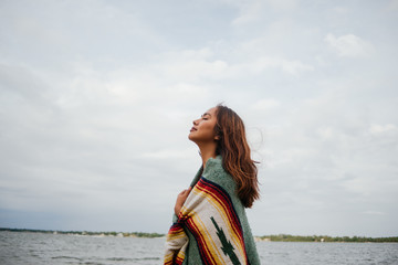 A young woman wrapped in a thick blanket