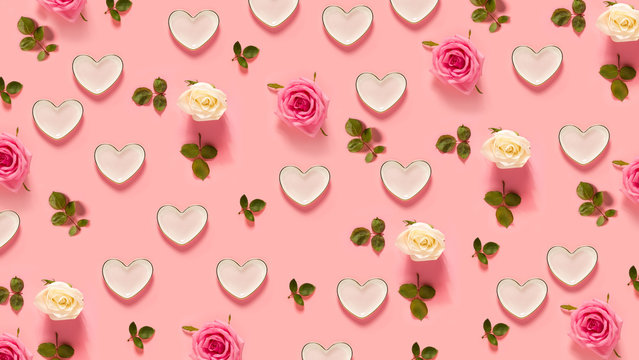 Pink roses and hearts on a pastel pink background