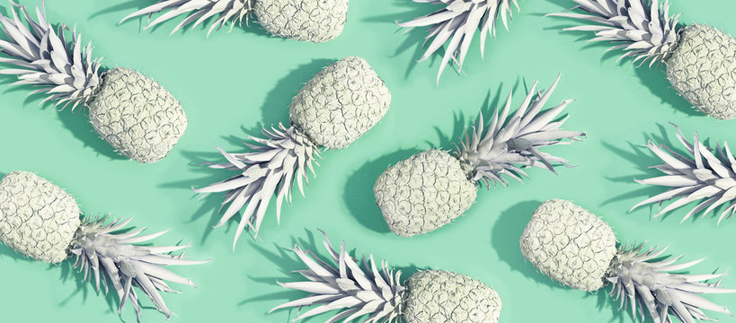Painted pineapples on a pastel green background