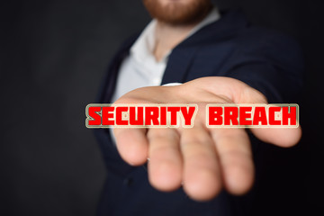 In the hands of a businessman the inscription:SECURITY BREACH