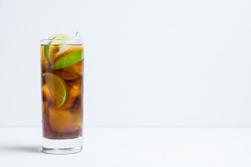 Cuba libre cocktail on the rustic background. Selective focus.