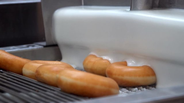 Donuts on industrial conveyor industrial machine