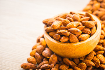Almonds nut in wooden bowl