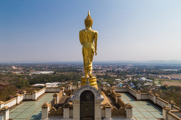 Fototapeta na wymiar Golden buddha statue looking to city