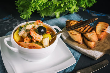 French fish soup Bouillabaisse with seafood, salmon fillet, shrimp, rich flavor, delicious dinner...
