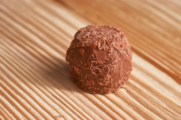 Macro. Chocolate candies on a light wooden background