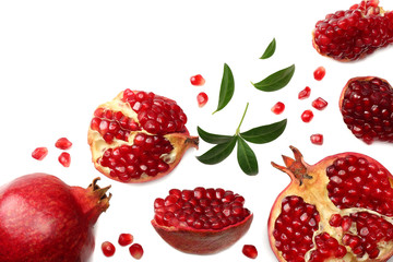pomegranate fruit with green leaves isolated on a white background top view