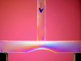 A force of 50 Newton is added from above (indicated by arrow) to a transparent balk with a recess....