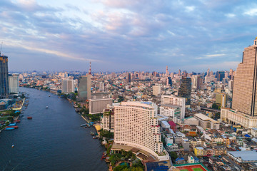 Fototapeta na wymiar Bangkok cityscape aerial view colorful sunset business district with river bridge