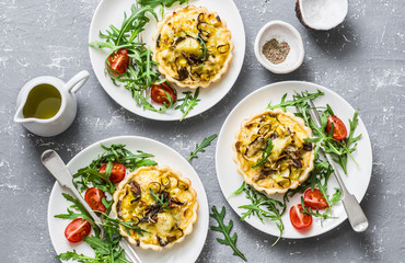 Vegetarian savory hands pie with porcini mushrooms, leeks, potatoes and arugula, tomatoes salad on...