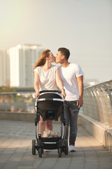 Affectionate Couple Walking with Baby