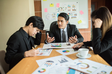 Close up of business people working with business document during discussion at meeting.