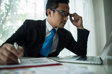 Young businessman working with laptop at office