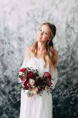 Beautiful young bride in wedding dress on canvas background with pastel, delicate image with bright...