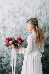 Beautiful young bride in wedding dress on canvas background with pastel, delicate image with bright...