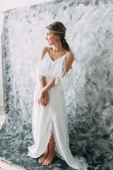 Beautiful young bride in wedding dress on canvas background with pastel, delicate image with bright...