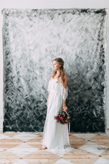 Beautiful young bride in wedding dress on canvas background with pastel, delicate image with bright...