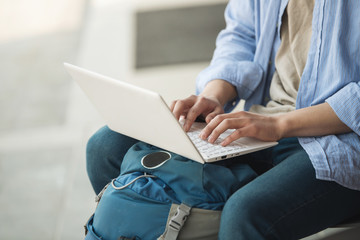 Asian man backpacking using laptop