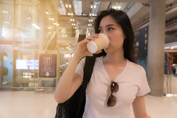 Beautiful young woman drinking coffee..For the hustle and bustle of traveling..Copy space.
