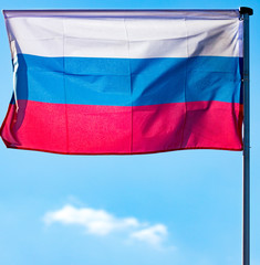 Flag of the Russian Federation against the blue sky