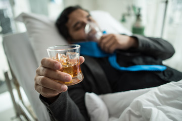 Businessman Working on Hospital Bed with Saline Solution On Patients Hand