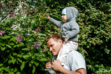 baby one year old sitting on dad's neck