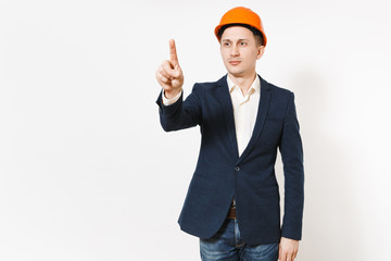 Young handsome businessman in dark suit, protective construction orange helmet touch something like click or push on button isolated on white background. Male worker, advertisement. Business concept.