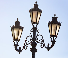 Ancient street lamp on the sky background