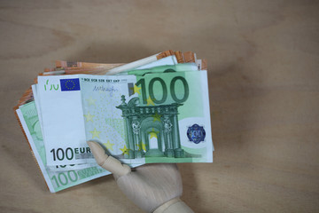 banknotes with hand, woodhand, wooden background