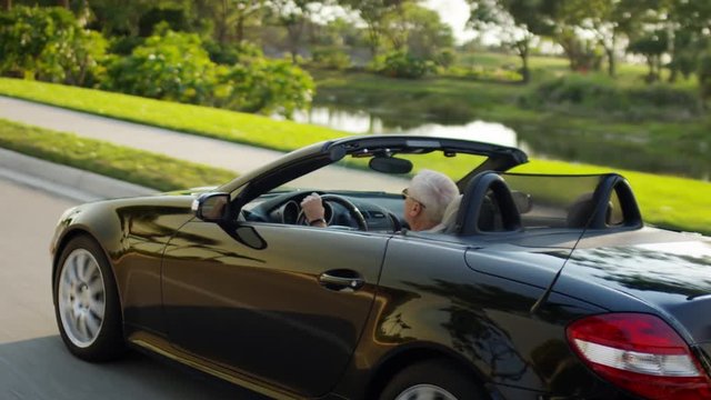 Active Senior Man Drives Past Golf Course In His Luxury Convertible, In Sunny Florida - Shot On Red Scarlet-W Dragon In 4K/ Slow Motion