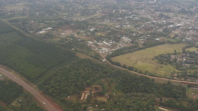 Aerial view of a city and a forest