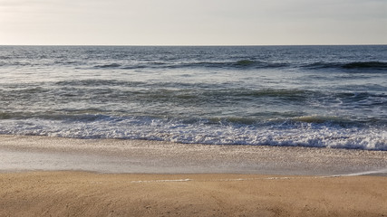 Fototapeta na wymiar Sea surf on the beach on a sunny day