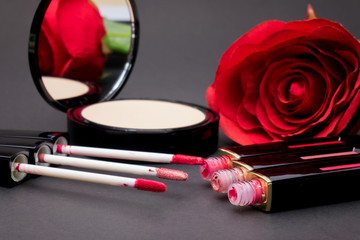 Obraz na płótnie Canvas Flowers rose,Powder and lipstick brush uses lips on black background