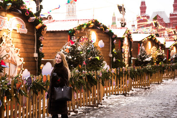 Portrait in full growth, Russian beautiful woman in a mink coat on the Red Square in Moscow in Christmas time